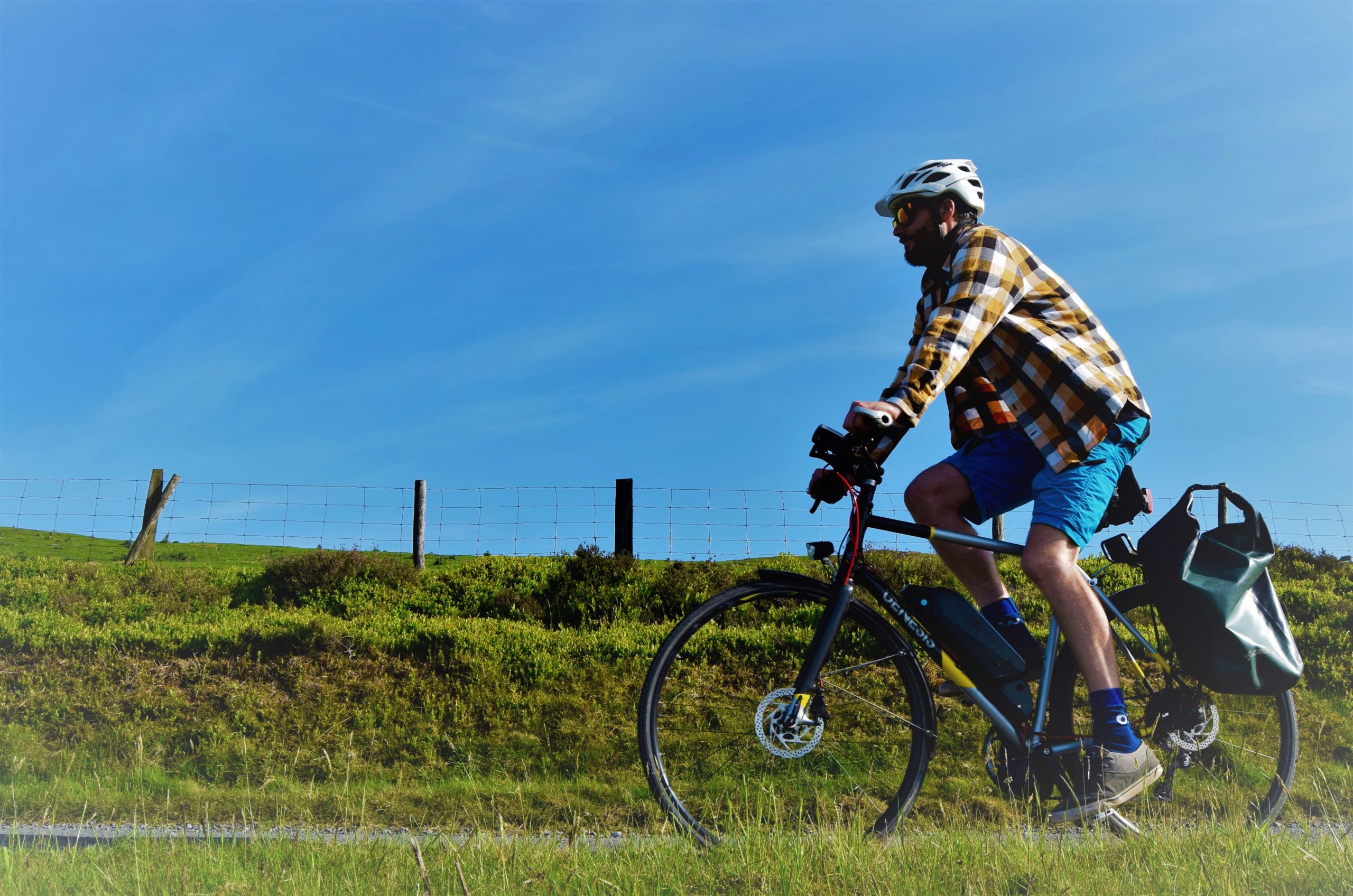 Cyclist on a converted e-bike in the sunny countryside