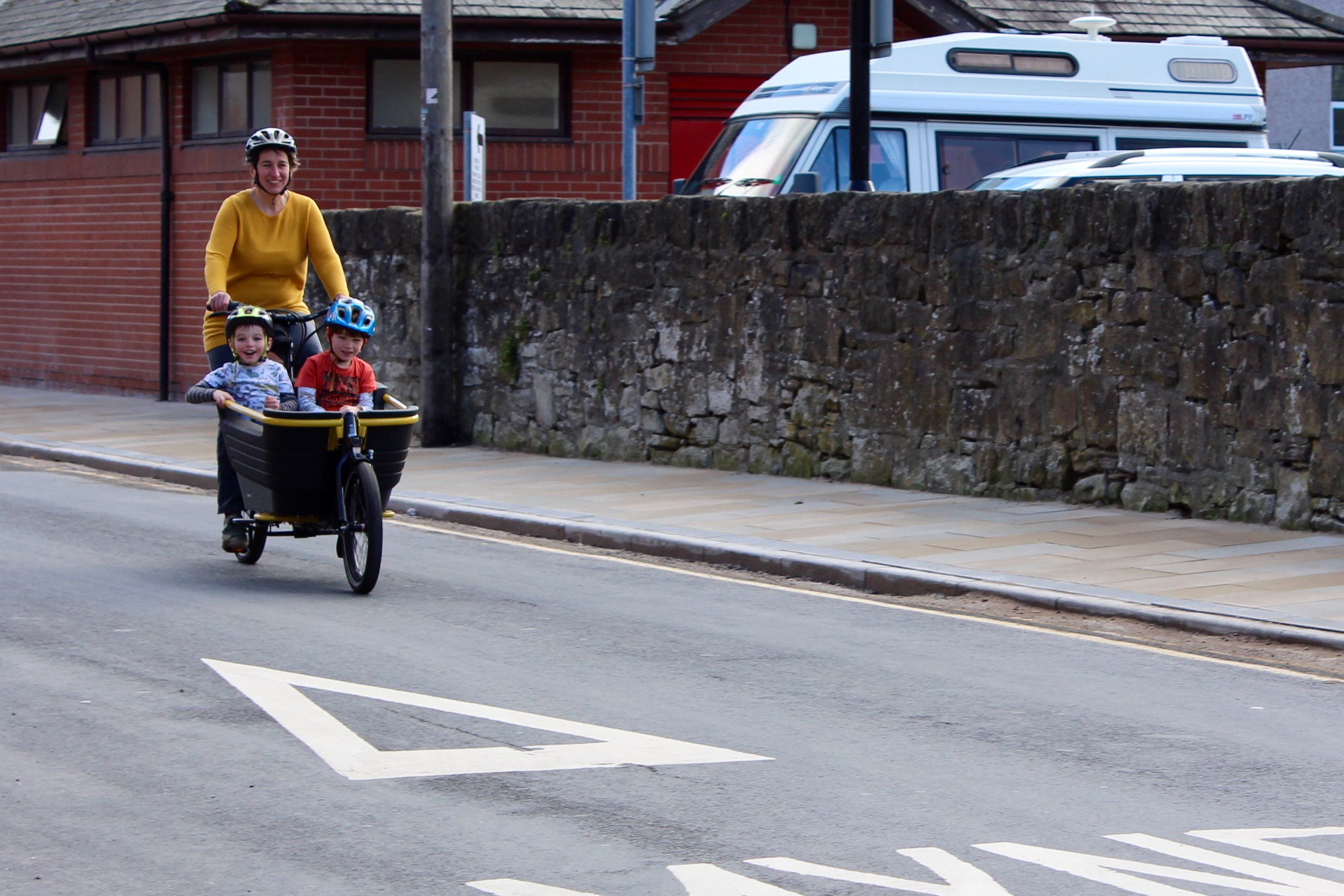 Family enjoying a cycle ride on an e-cargo bike