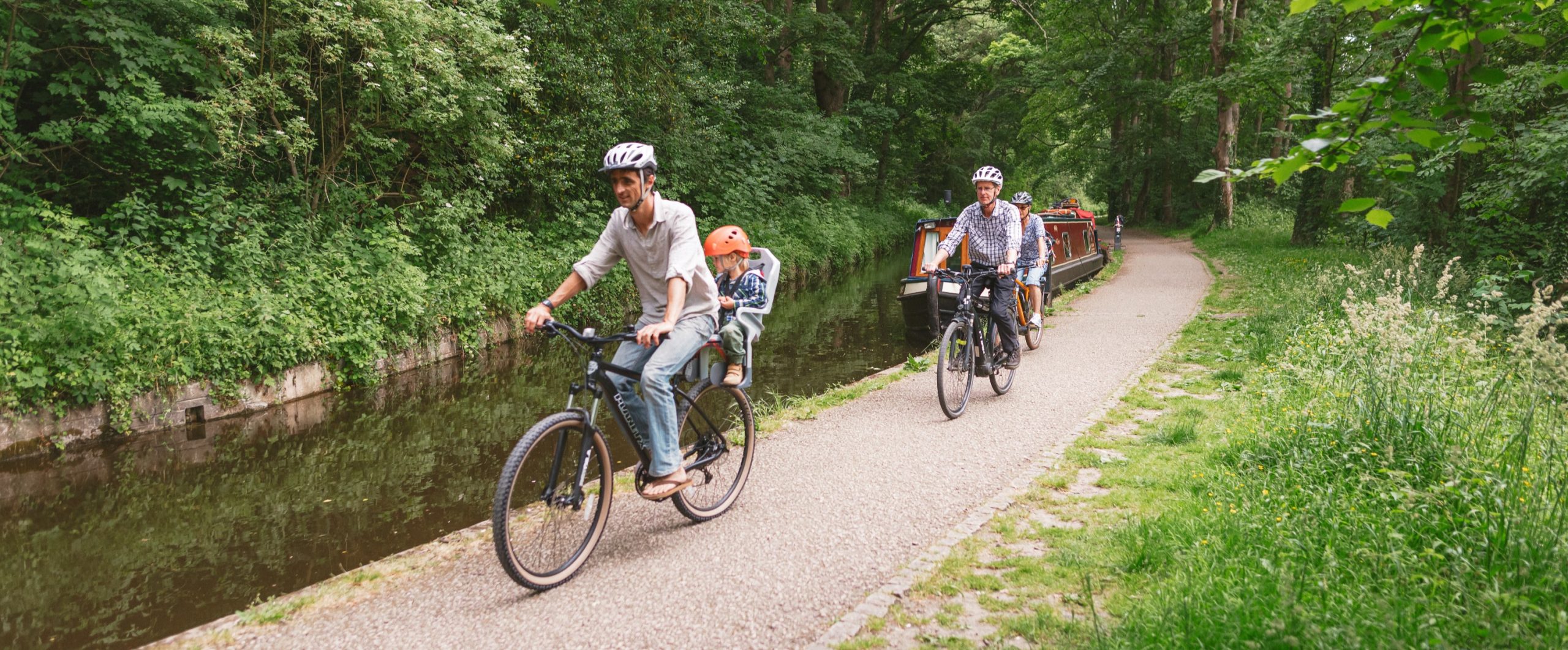 Family cycling along the Llangollen canal path